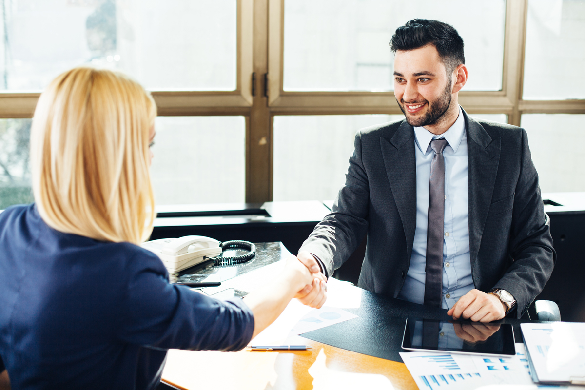 Businessman and businesswoman handshake in the office